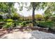 Landscaped backyard with stone accents and flower beds at 7402 America Way, New Port Richey, FL 34654
