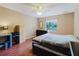 Bedroom with hardwood floors, ceiling fan, a window and closet at 7402 America Way, New Port Richey, FL 34654