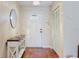 Bright foyer with hardwood floors and decorative table at 7402 America Way, New Port Richey, FL 34654
