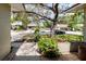 View of front yard landscaping featuring mature trees and plantings at 7402 America Way, New Port Richey, FL 34654