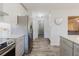 Well-lit kitchen showcases stainless steel appliances, white subway tile backsplash, and seamless flow into dining area at 7402 America Way, New Port Richey, FL 34654