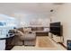 Spacious living room with comfortable seating and view of the kitchen at 7402 America Way, New Port Richey, FL 34654
