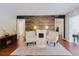 Stylish living room with fireplace and wood accent wall at 7402 America Way, New Port Richey, FL 34654