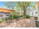 Spacious backyard features brick patio, fountain, garden and large shade tree at 7603 N 53Rd St, Tampa, FL 33617