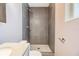 Modern bathroom with a sleek vanity, mirror, toilet, and tiled shower at 7603 N 53Rd St, Tampa, FL 33617