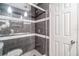 Bathroom featuring glass enclosed shower with decorative tile and overhead lighting at 7603 N 53Rd St, Tampa, FL 33617