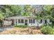 One story home with carport and mature trees and landscaping in the front yard at 7603 N 53Rd St, Tampa, FL 33617