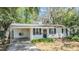 Well-kept one-story home featuring a carport and neatly maintained landscaping at 7603 N 53Rd St, Tampa, FL 33617