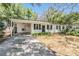 Charming single-story home with a carport, manicured lawn, and lush landscaping offers curb appeal at 7603 N 53Rd St, Tampa, FL 33617