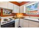 Charming kitchen features white cabinets, wood countertops, and a garden view at 7603 N 53Rd St, Tampa, FL 33617