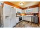 Charming kitchen featuring white cabinetry, stainless appliances, and wood look flooring at 7603 N 53Rd St, Tampa, FL 33617