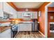 Cozy kitchen featuring wood countertops, white cabinetry and stainless steel appliances at 7603 N 53Rd St, Tampa, FL 33617