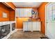 The laundry room has storage cabinets, countertops, washer and dryer at 7603 N 53Rd St, Tampa, FL 33617