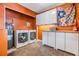 Functional laundry room includes washer, dryer, storage and water heater at 7603 N 53Rd St, Tampa, FL 33617