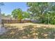 Expansive, fenced backyard with mature trees, offering privacy and space for outdoor activities and landscaping opportunities at 850 Center Ave, Brandon, FL 33511