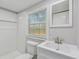 A bathroom features a new vanity, lighting and tiled shower at 850 Center Ave, Brandon, FL 33511