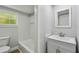 Bright bathroom with tub, shower and modern single sink vanity at 850 Center Ave, Brandon, FL 33511