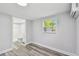 Bedroom featuring a bathroom and modern flooring at 850 Center Ave, Brandon, FL 33511