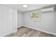 Cozy bedroom featuring wood-look flooring, a window, and a closet at 850 Center Ave, Brandon, FL 33511