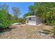 Rear view of a charming home surrounded by palm trees, lush green bushes and well-kept grounds at 850 Center Ave, Brandon, FL 33511