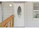 Charming front entrance featuring a decorative glass door and light gray siding, exuding curb appeal at 850 Center Ave, Brandon, FL 33511