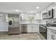 Modern kitchen featuring stainless steel appliances, white cabinets, and quartz countertops at 850 Center Ave, Brandon, FL 33511
