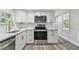 A bright kitchen features white cabinets and stainless steel appliances at 850 Center Ave, Brandon, FL 33511