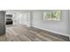 Open-concept space with new floors connects the living room to the kitchen at 850 Center Ave, Brandon, FL 33511