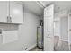 Utility room with hot water tank and cabinets at 850 Center Ave, Brandon, FL 33511