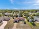An aerial view of a home, surrounded by lush greenery and well manicured lawns at 9010 Bonnet Way, Weeki Wachee, FL 34613