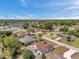 An aerial view of a neighborhood with mature trees, serene lakes, and well-maintained lawns at 9010 Bonnet Way, Weeki Wachee, FL 34613