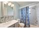 Bathroom featuring a modern vanity, floral shower curtain, and tiled shower/tub combo at 9010 Bonnet Way, Weeki Wachee, FL 34613