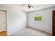 This well-lit bedroom features a ceiling fan and window at 9010 Bonnet Way, Weeki Wachee, FL 34613