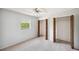 Bedroom featuring open, louvered closets and window with lush foliage views at 9010 Bonnet Way, Weeki Wachee, FL 34613