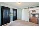 Cozy bedroom with a barn door leading to the updated kitchen, large windows, and dark curtains at 9010 Bonnet Way, Weeki Wachee, FL 34613
