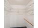 Walk-in closet with white wire shelving and dark carpeting at 9010 Bonnet Way, Weeki Wachee, FL 34613