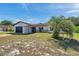 An inviting single-story home with attached two car garage, beautiful front yard, and neutral exterior at 9010 Bonnet Way, Weeki Wachee, FL 34613