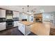 Modern kitchen featuring a center island, stainless steel appliances, and an open layout with a stone fireplace at 9010 Bonnet Way, Weeki Wachee, FL 34613