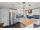 Contemporary kitchen design with stainless steel refrigerator, center island, and custom backsplash at 9010 Bonnet Way, Weeki Wachee, FL 34613
