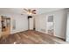 Main bedroom featuring neutral walls, laminate floors, closet, and a ceiling fan at 9010 Bonnet Way, Weeki Wachee, FL 34613