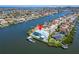 Stunning aerial view of waterfront house with dock, lush landscaping, and pool at 935 Chipaway Dr, Apollo Beach, FL 33572