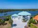 Beautiful Waterfront Property: Aerial view featuring a private dock, lush landscaping, and stunning views of the surrounding bay at 935 Chipaway Dr, Apollo Beach, FL 33572