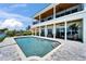 Backyard featuring a pool, covered patio, and water views, providing a perfect setting for relaxation and entertainment at 935 Chipaway Dr, Apollo Beach, FL 33572