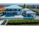 Luxury waterfront home featuring a swimming pool, a covered patio, and scenic water views for outdoor enjoyment at 935 Chipaway Dr, Apollo Beach, FL 33572