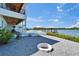 Backyard featuring a fire pit, pool, and waterfront access, ideal for outdoor entertaining and relaxation at 935 Chipaway Dr, Apollo Beach, FL 33572