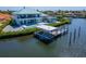 Backyard featuring a boat lift and outdoor living area at 935 Chipaway Dr, Apollo Beach, FL 33572