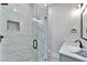 Modern bathroom features marble tile shower, sleek glass door and black hardware details at 935 Chipaway Dr, Apollo Beach, FL 33572