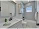 Bathroom features a large mirror and vanity, a window, and a shower over tub at 935 Chipaway Dr, Apollo Beach, FL 33572