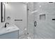 Bright bathroom offers a glass shower, a single sink, and modern finishes at 935 Chipaway Dr, Apollo Beach, FL 33572