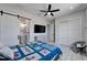 Spacious bedroom featuring wood-look tile floors, a ceiling fan, and an ensuite bathroom at 935 Chipaway Dr, Apollo Beach, FL 33572